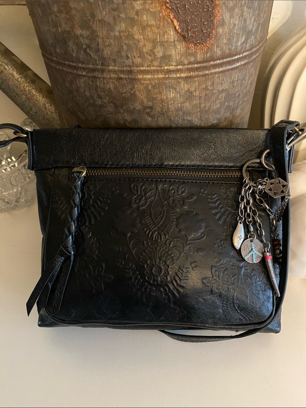 The Sak Sanibel Black Leather Floral Embossed Mini Crossbody w/ Gold Hardware